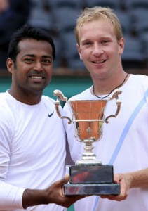 Lukas Dlouhy and Leander Paes accept the trophy after winning the 2009 French Open Championship in doubles.