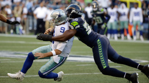 Romo is tackled by Seattle's Cliff Avril during a preseason game on Aug. 25. Romo suffered a compression fracture of his L1 vertebra on the play.
